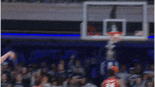a blurry picture of a basketball game with a player wearing a red jersey with the number 28 on it