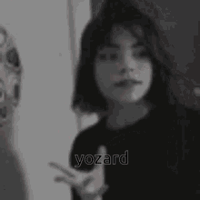 a woman 's face with a red smiley face and the word yozard in the corner