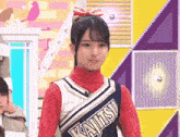 a cheerleader wearing a uniform with the word kajitsu on it