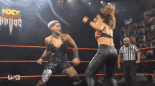 two women are wrestling in a ring with a referee and the word usa on the bottom right