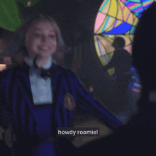 a girl in a purple and black striped jacket says howdy roomie