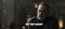 a man in a leather jacket is holding a bat and saying say that again .