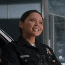 a woman in a police uniform has a name tag that says smith on it