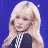 a close up of a woman with blonde hair and a microphone