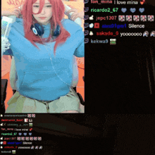 a girl with red hair and headphones is sitting in front of a screen that says fan mina i love mina on it