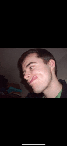 a young man making a funny face with his tongue hanging out
