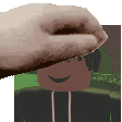 a close up of a person 's hand holding a picture of a person 's face .