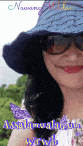 a woman wearing sunglasses and a hat with the words nawang milan written on it