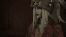 a woman with long white hair and a mask on her head