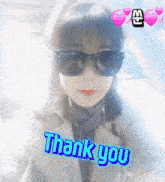 a woman wearing sunglasses says thank you in blue