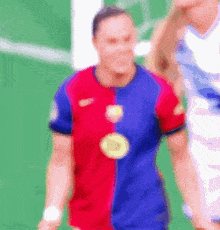 a blurry picture of a man in a red and blue shirt