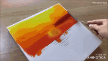 a person is painting a sunset with permanent red
