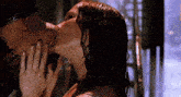 a man and a woman are kissing in the shower