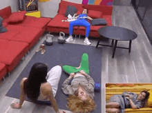 a group of women are sitting on the floor in a living room .