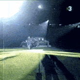 a blurry picture of a stadium with the number 3 on the bottom