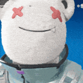 a white teddy bear with red crosses on its eyes and a smile