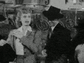 a black and white photo of a man and a woman standing next to each other