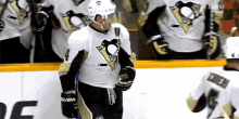 a hockey player in a pittsburgh penguins uniform