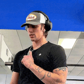 a man wearing headphones and a hat that says irish on it