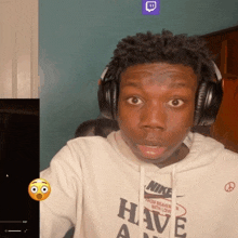 a man wearing headphones and a hoodie that says nike