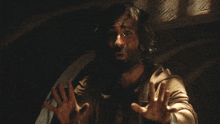 a man with a beard has his hands outstretched
