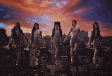 a group of women are standing on top of a city skyline