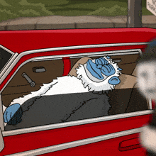 a cartoon monkey is sleeping in a red car
