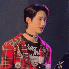 a young man wearing a choker and a plaid shirt that says " req me "