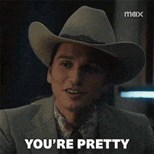 a man wearing a cowboy hat says " you 're pretty "