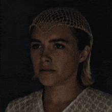 a close up of a woman wearing a hat
