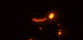 a close up of a person 's face with flames coming out of it in a dark room .