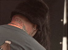 a close up of a person 's neck with a tattoo on it