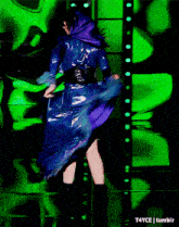 a woman in a blue dress is dancing in front of a green background that says t4yce tumblr on the bottom
