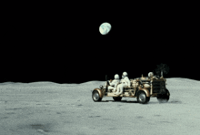 two astronauts are driving a vehicle on the moon with the earth in the background