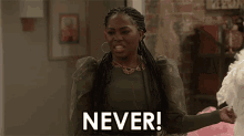 a woman in a green sweater is saying never .