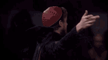 a man with a beard is holding a globe in his hands