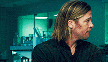 a man with long hair and a beard has a bloody face