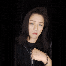 a woman wearing a black jacket with the letter h on it