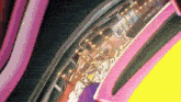 a close up of a pink brush with gold pins