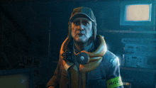 a man wearing a hat and headphones has a yellow armband that says watt