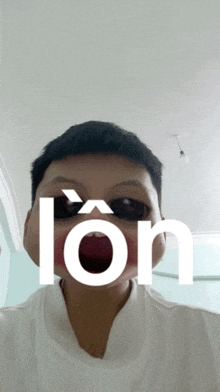 a boy wearing sunglasses and a white shirt with the word lon on his face