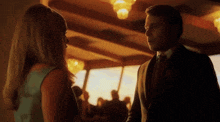 a man and a woman are looking at each other