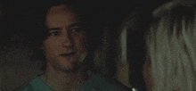 a man in a scrub top is smiling at a woman