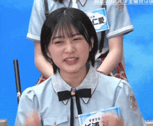 a girl wearing a name tag that says ok