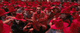 a group of people wearing red hats are dancing in a club