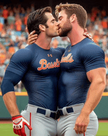 two baseball players are kissing on the field and one of them is wearing a shirt that says basebals