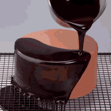 a chocolate cake is being glazed with chocolate icing