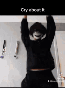 a person is hanging upside down with their arms in the air and a caption that says cry about it