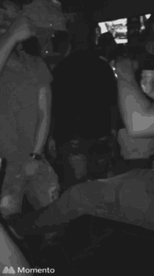 a black and white photo of a crowd with the words momento on the bottom right