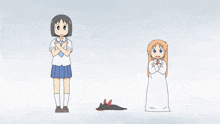 a girl in a school uniform stands next to a cat